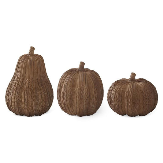 Three brown textured pumpkins on a white background