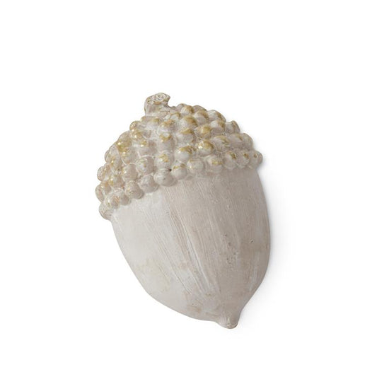 Cream and gold acorn of home decor, featuring textured detailing and decorative spots.