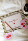 Meal planner with cherry design on a white surface