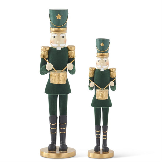 Dark green velvet soldier by Raz Imports, with gold trim and black boots, standing on a round gold base.
