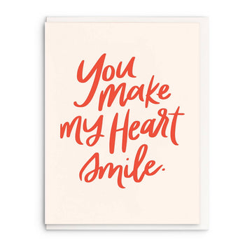 Letterpress greeting card with "You make my heart smile" message in coral script.