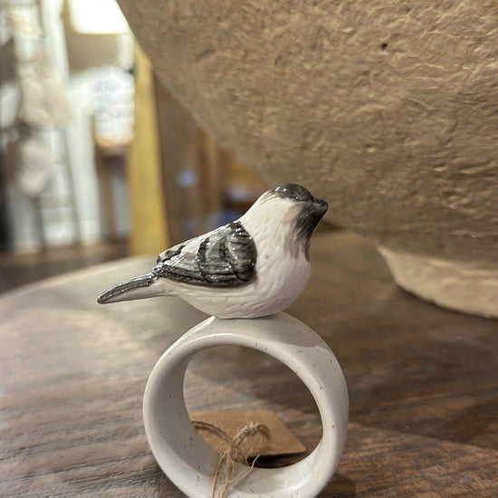 White stoneware napkin ring with bird by Park Hill, with speckled glaze and brown paper tag.
