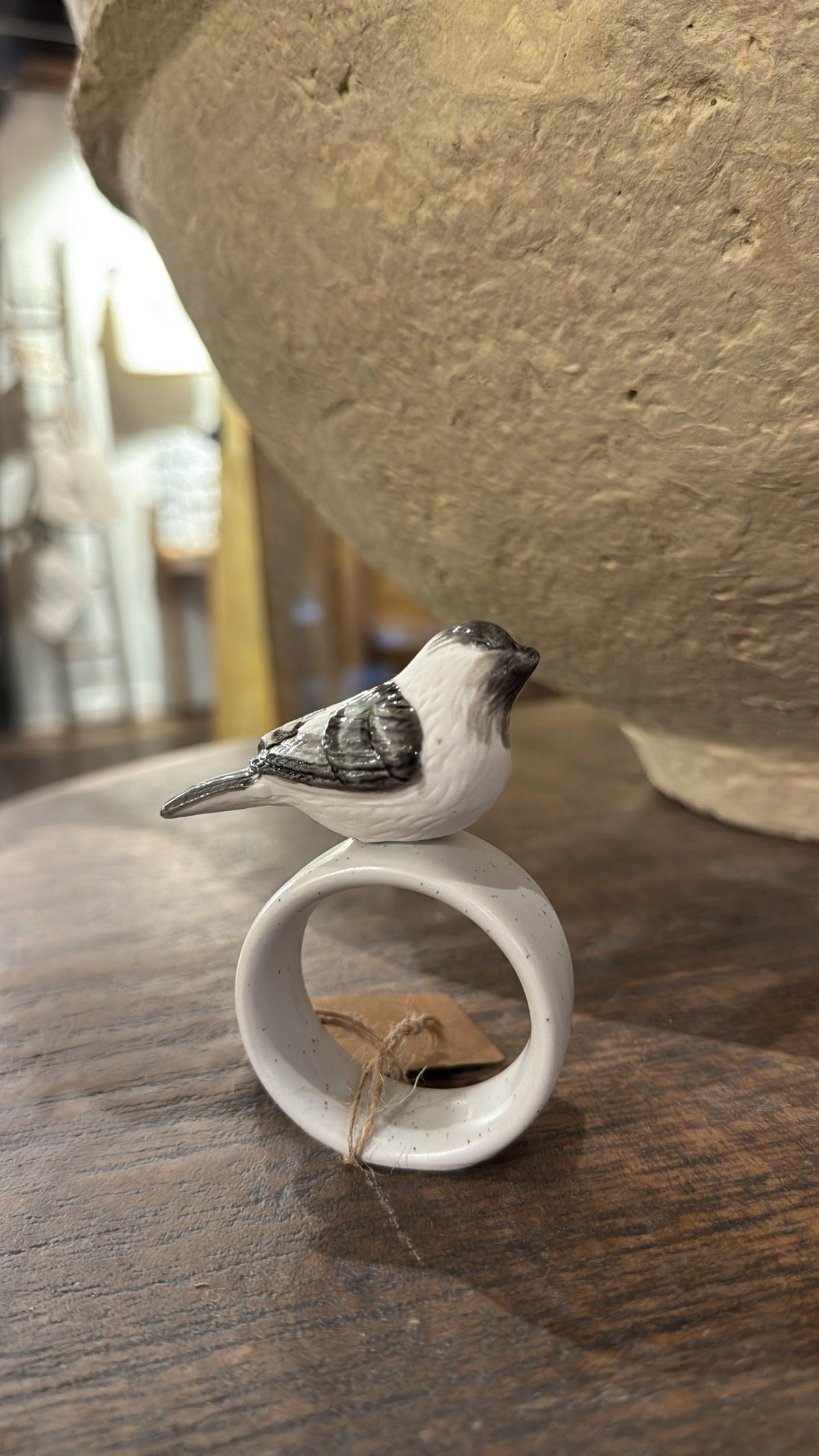 White stoneware napkin ring with bird by Park Hill, with speckled glaze and brown paper tag.
