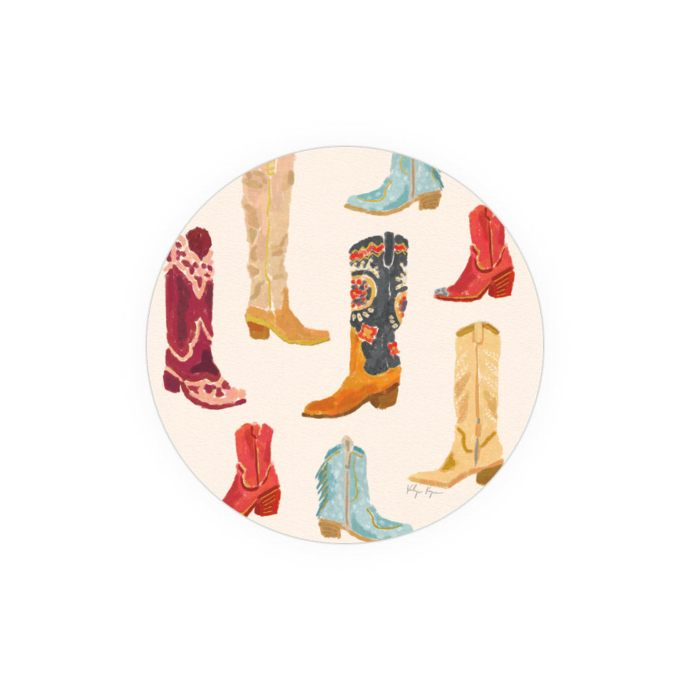 Round art print coasters with colorful cowboy boot pattern on a beige background.