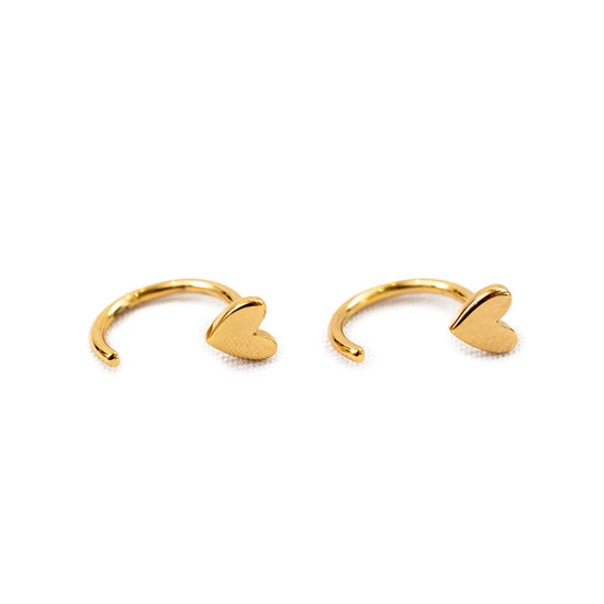 Gold huggie earrings with heart detail, small and shiny.