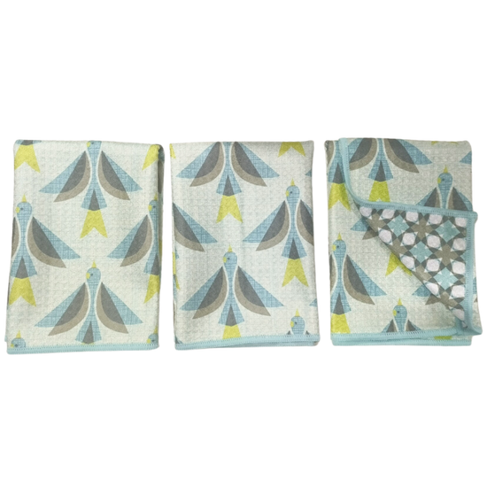 Set of three reversible multicolor mini towels by HJ Sparrow, featuring a geometric bird pattern and blue trim.
