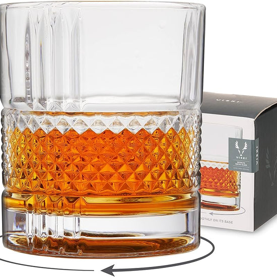 Clear rocks glass by Viski with diamond pattern and liquid contents, next to matching box.