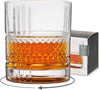Clear rocks glass by Viski with diamond pattern and liquid contents, next to matching box.