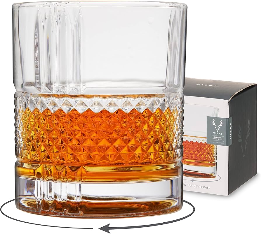 Clear rocks glass by Viski with diamond pattern and liquid contents, next to matching box.