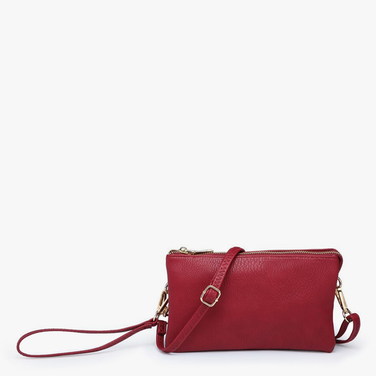 Wine crossbody wristlet with multiple compartments, featuring a pebbled texture.