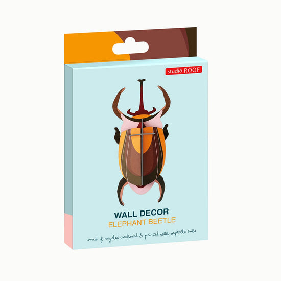Elephant beetle wall decor by studio ROOF featuring a colorful design on recycled cardboard.