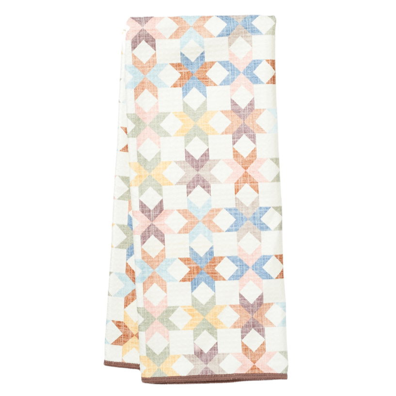 Multicolor dish towel with star quilt pattern by Crate & Barrel, with textured surface and a brown trim.