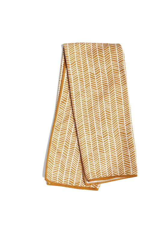 Gold towel with branches pattern from Kitchen & Tabletop, folded with a border.
