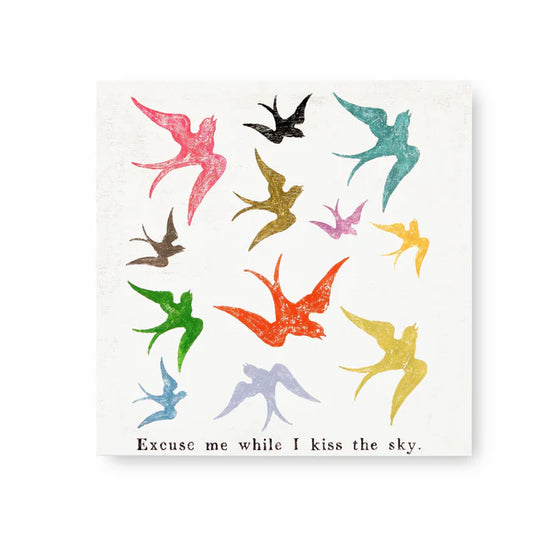 Square art tile by an unknown brand featuring colorful swallows and the phrase "Excuse me while I kiss the sky".
