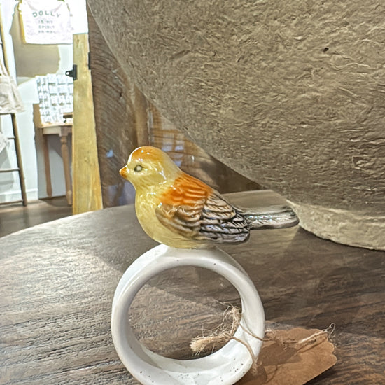 Stoneware napkin ring with bird by Creative Co-op, featuring a glazed finish and decorative jute string.