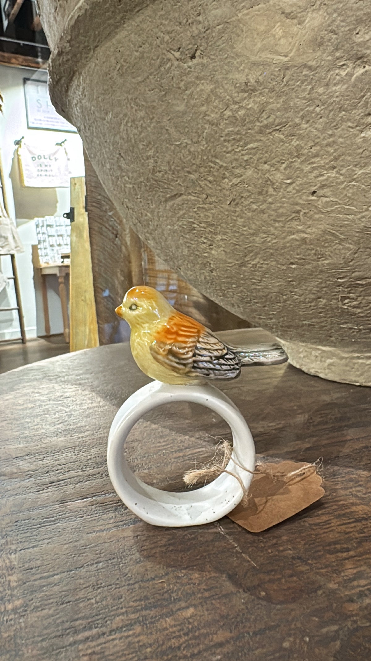 Stoneware napkin ring with bird by Creative Co-op, featuring a glazed finish and decorative jute string.