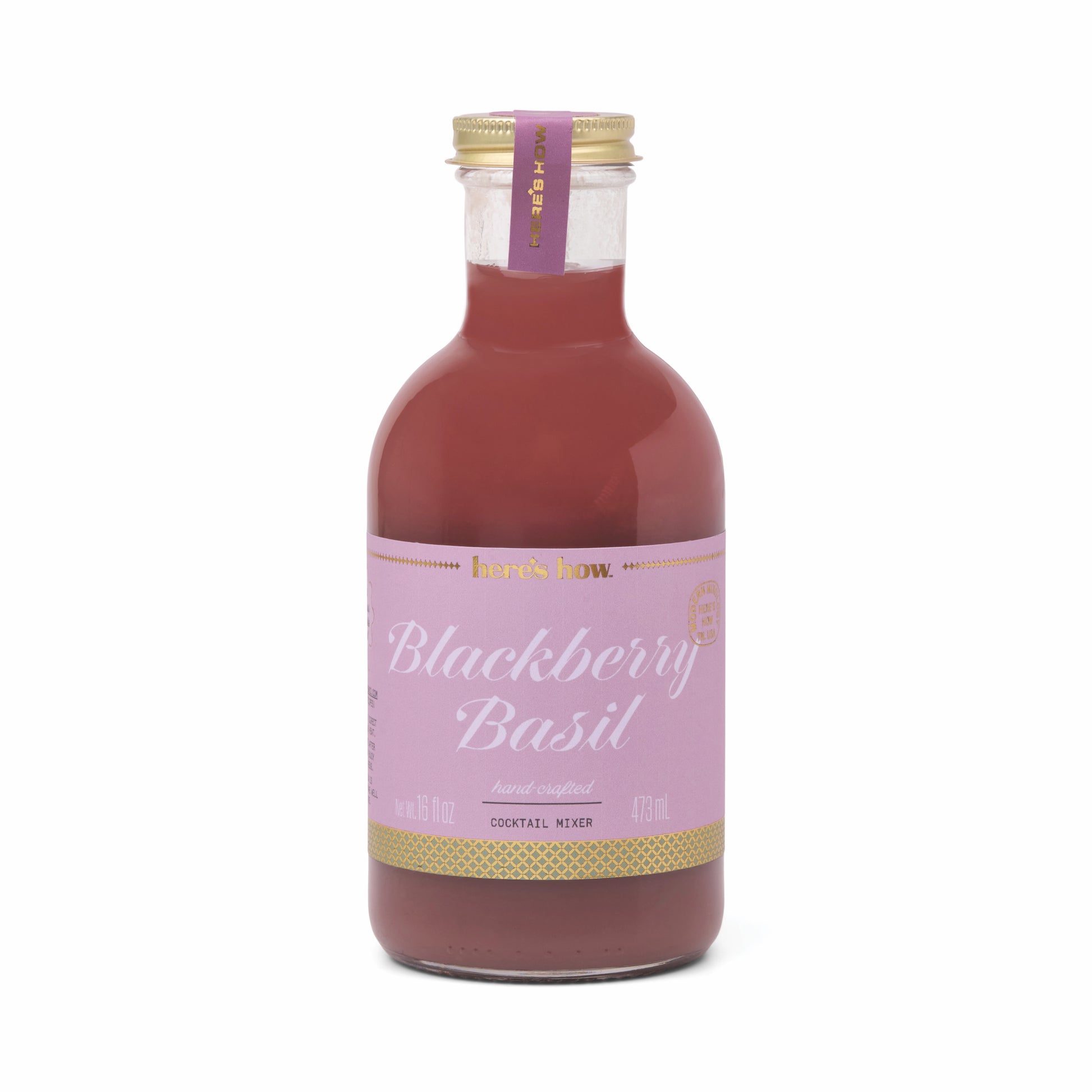 Blackberry Basil Cocktail Mixer by Here's How, in a clear glass bottle with a gold cap.