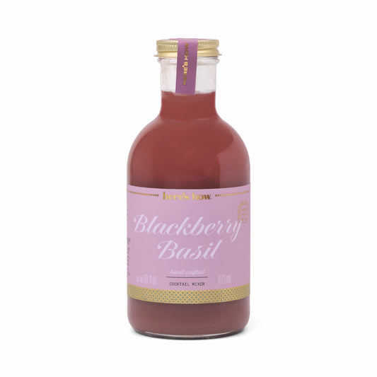 Blackberry Basil Cocktail Mixer by Here's How, in a clear glass bottle with a gold cap.