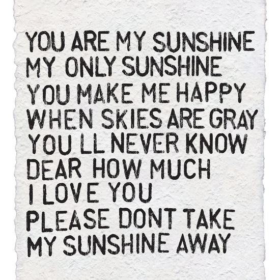 Handmade paper print by unknown vendor, featuring the "You Are My Sunshine" song lyrics in black ink on textured white paper.
