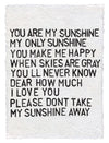 Handmade paper print by unknown vendor, featuring the "You Are My Sunshine" song lyrics in black ink on textured white paper.

