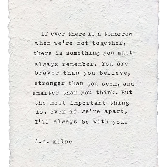 Handmade paper print with a quote by A.A. Milne, showing a rough, textured surface and torn edges.
