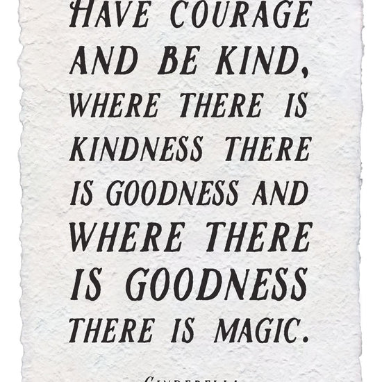 Handmade paper print with the quote "Have courage and be kind" in black ink on textured paper.
