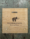 Wood art tile from Sugarboo & Co., featuring an elephant graphic, with a saw-tooth hanger on the back.