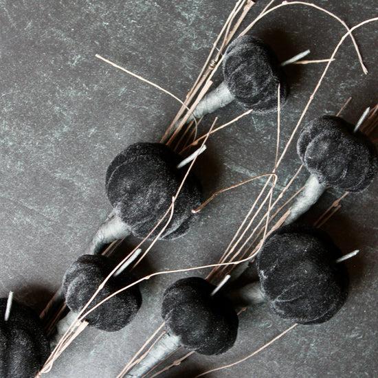 Black velvet pumpkin stem with twig accents.