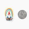 Mini stationery sticker with a gnome under a rainbow and the word "Gnomesté," next to a quarter for scale.