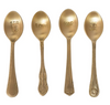 Gold-toned engraved spoons with unique handle designs, each stamped with a different phrase.