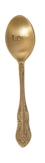 Golden engraved spoon with the word "Love" on the bowl, and ornate detailing on the handle.