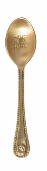 Gold engraved spoon with "Hug in a Mug" text on the head, decorative patterns on the handle.