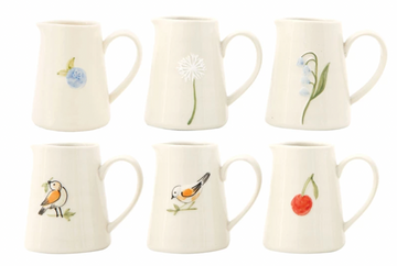 White hand-painted creamer with floral and bird designs.