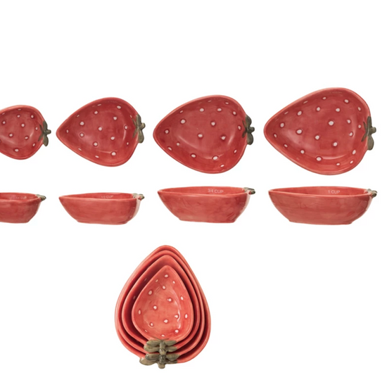 Strawberry shaped measuring cups by Thirstystone, featuring a red exterior with white dots and a nested design.
