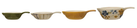 Set of stoneware measuring cups with hand-painted floral and plaid patterns.