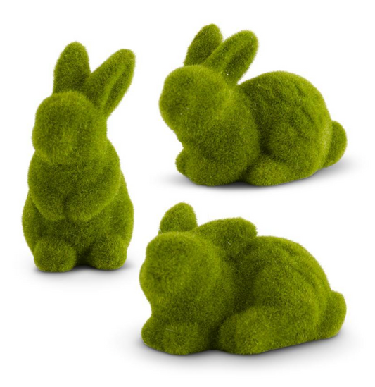 Three green flocked bunny decorations in different positions.