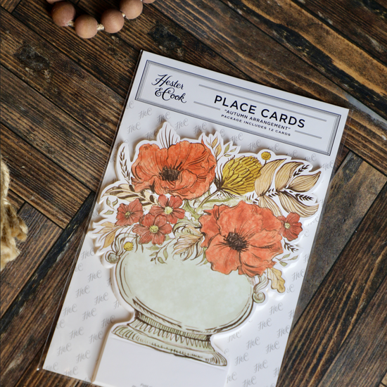 Autumn arrangement place cards by Hester & Cook with floral design and space for writing names.
