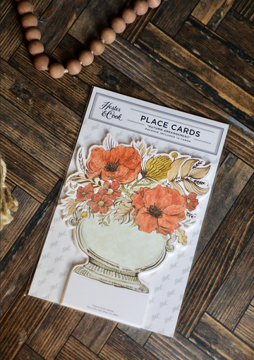 Autumn arrangement place cards by Hester & Cook with floral design and space for writing names.
