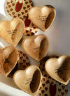 Wood carved trinket trays with various inspirational quotes, with patterned coasters underneath.