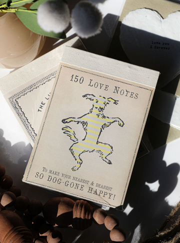 Love notes notepad from an unseen vendor, featuring a cartoon dog in yellow stripes.