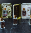 Luxe bath and body product from Tokyo Milk, with square bottles and gold caps displayed in decorative tins.
