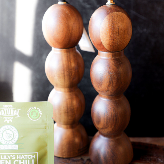 Acacia wood salt and pepper mills, set of two, in a stacked spherical shape.