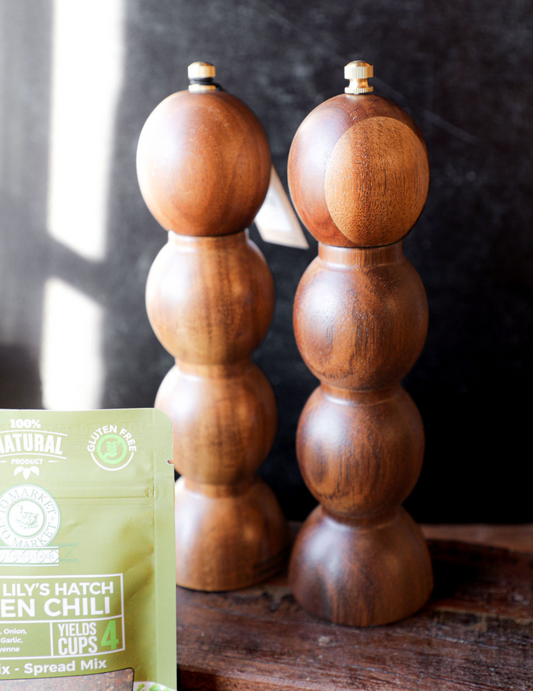 Acacia wood salt and pepper mills, set of two, in a stacked spherical shape.