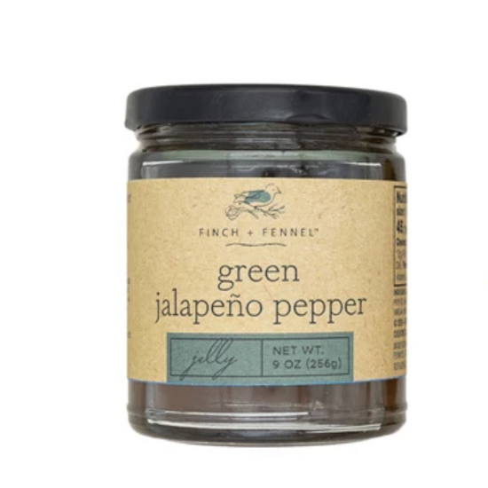 Green jalapeño pepper jelly by Finch + Fennel in a glass jar with a black lid.