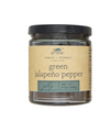 Green jalapeño pepper jelly by Finch + Fennel in a glass jar with a black lid.