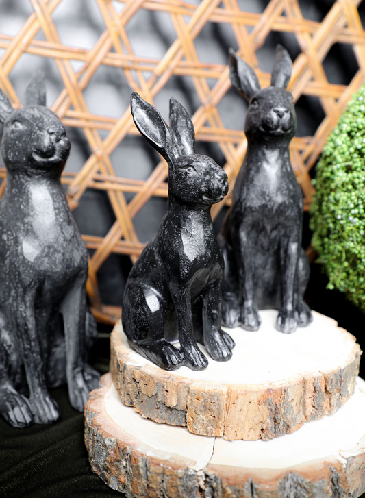 Faux cast iron rabbit by Foreside Home and Garden on a wood slice pedestal.