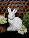 White faux concrete rabbit from Home Decor, surrounded by flowers and greenery.