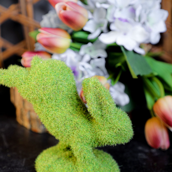 Green moss bunny by Park Designs standing on front feet with artificial flowers in the background.