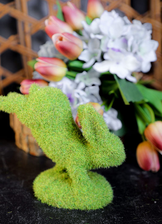 Green moss bunny by Park Designs standing on front feet with artificial flowers in the background.