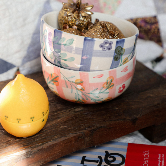 Decorative bowl with floral pattern on a wooden surface